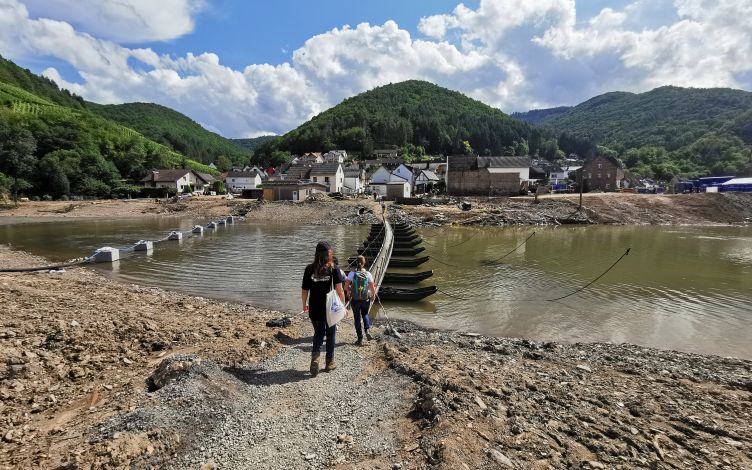 Two women crossing a river.