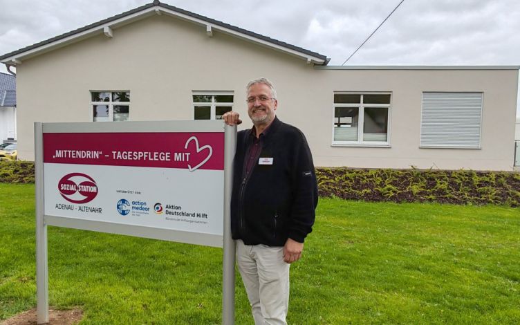 A man standing in front of a newly built house.