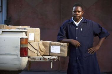 A man loads a pick-up with packages of action medeor.