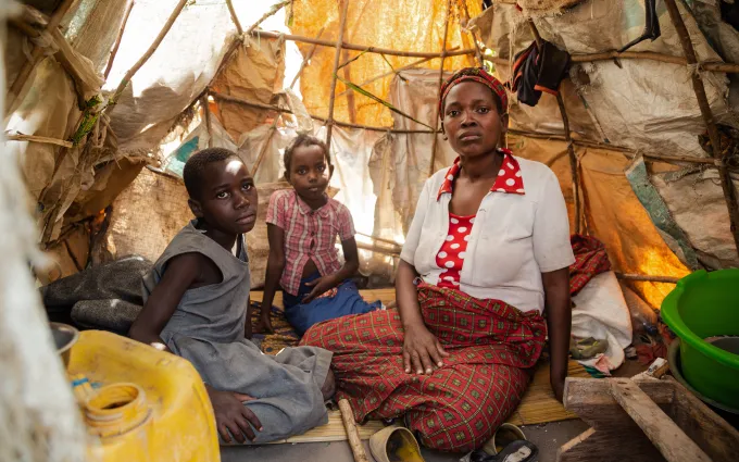 Children and a woman in a tent.